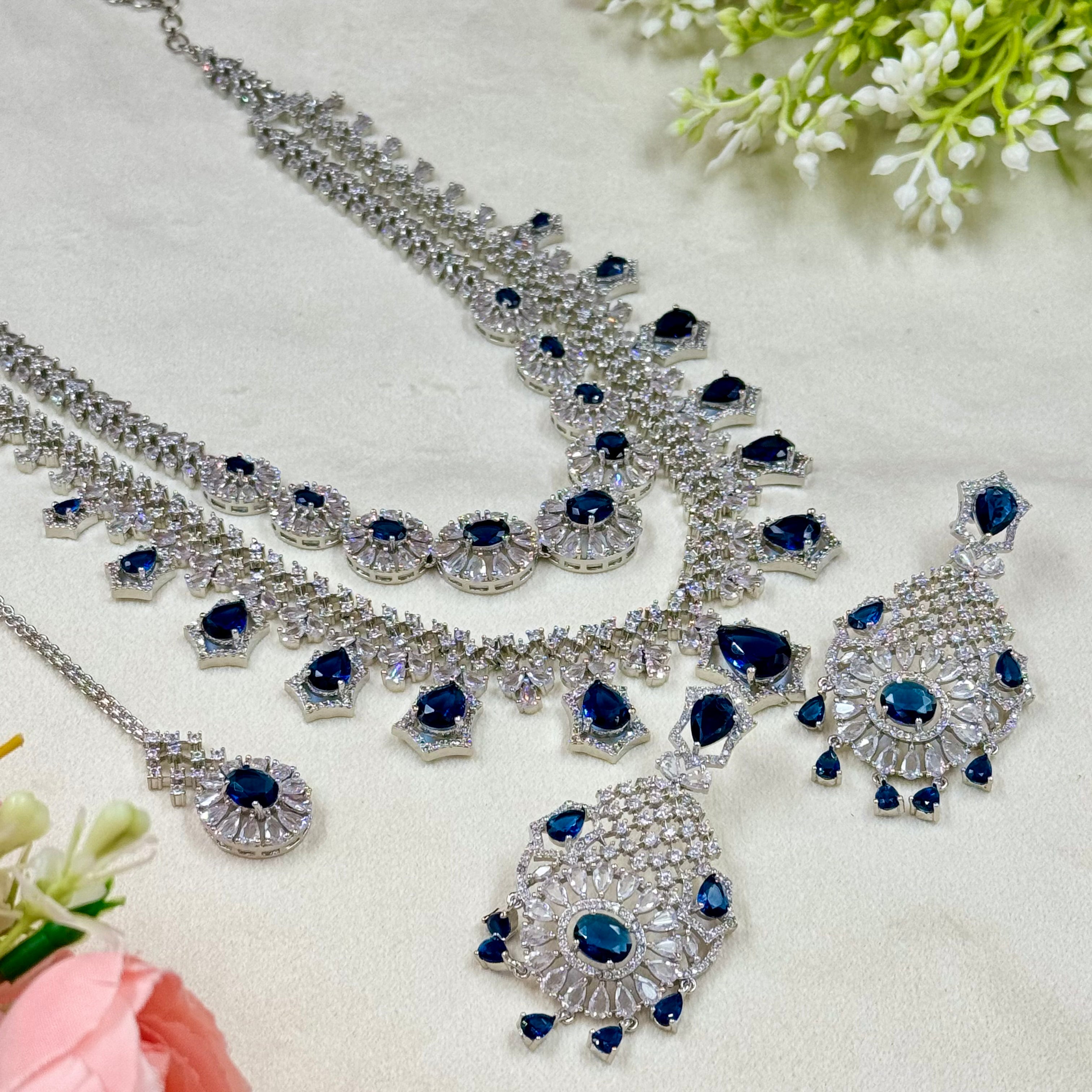 Silver necklace with blue stones on a light background