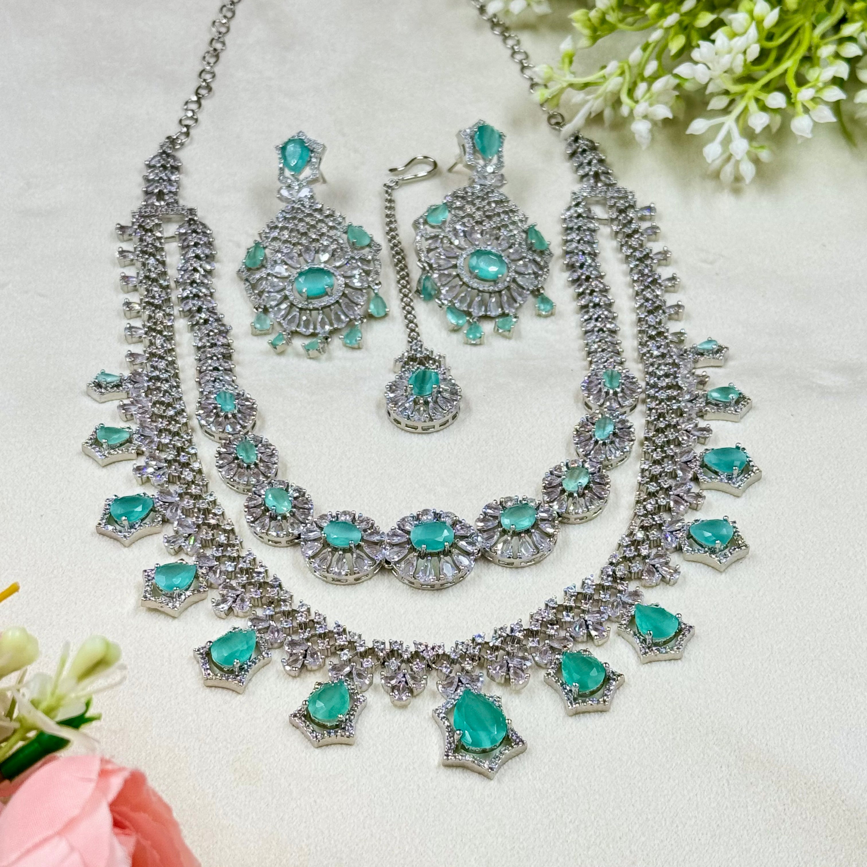 Jewelry set with necklace and earrings on a light background