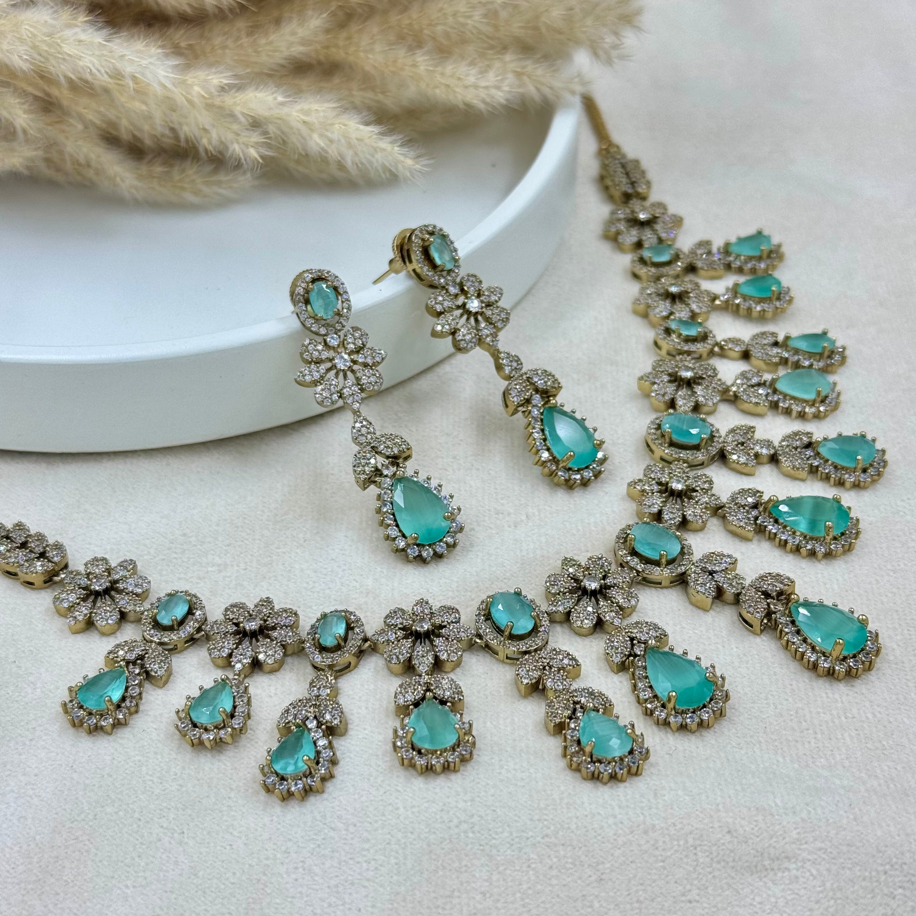 Jewelry set with turquoise stones on a neutral background