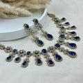 Jewelry set with blue gemstones on a light background