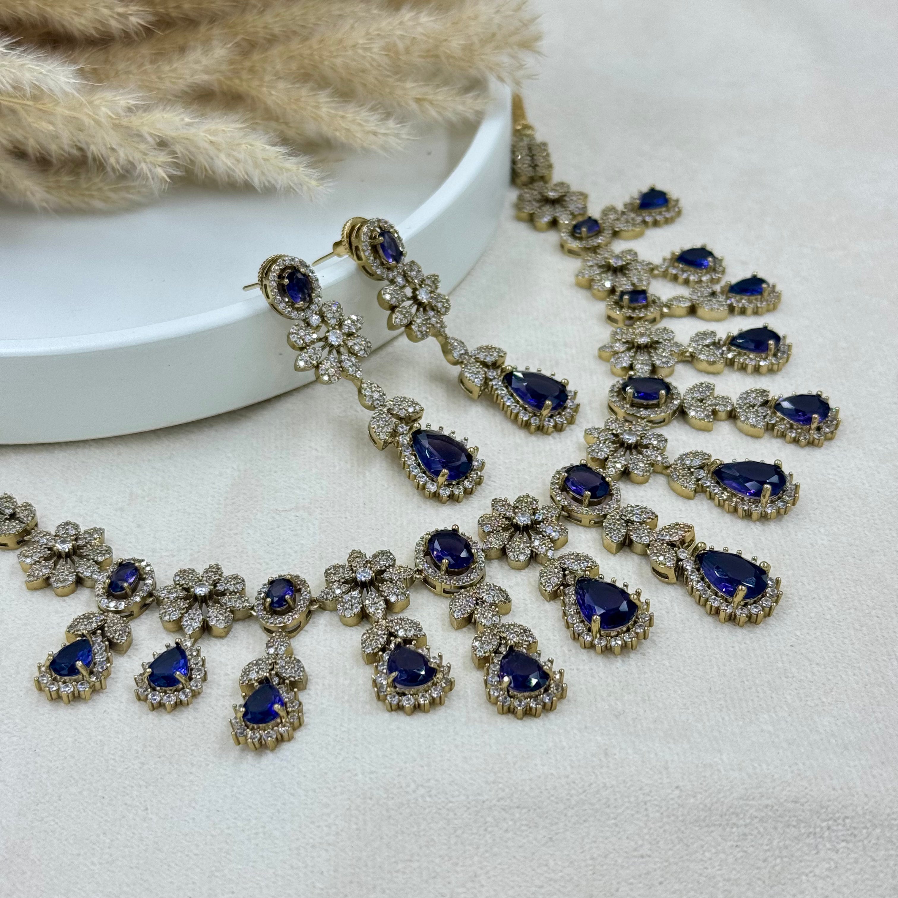 Ornate necklace with blue gemstones on a white surface