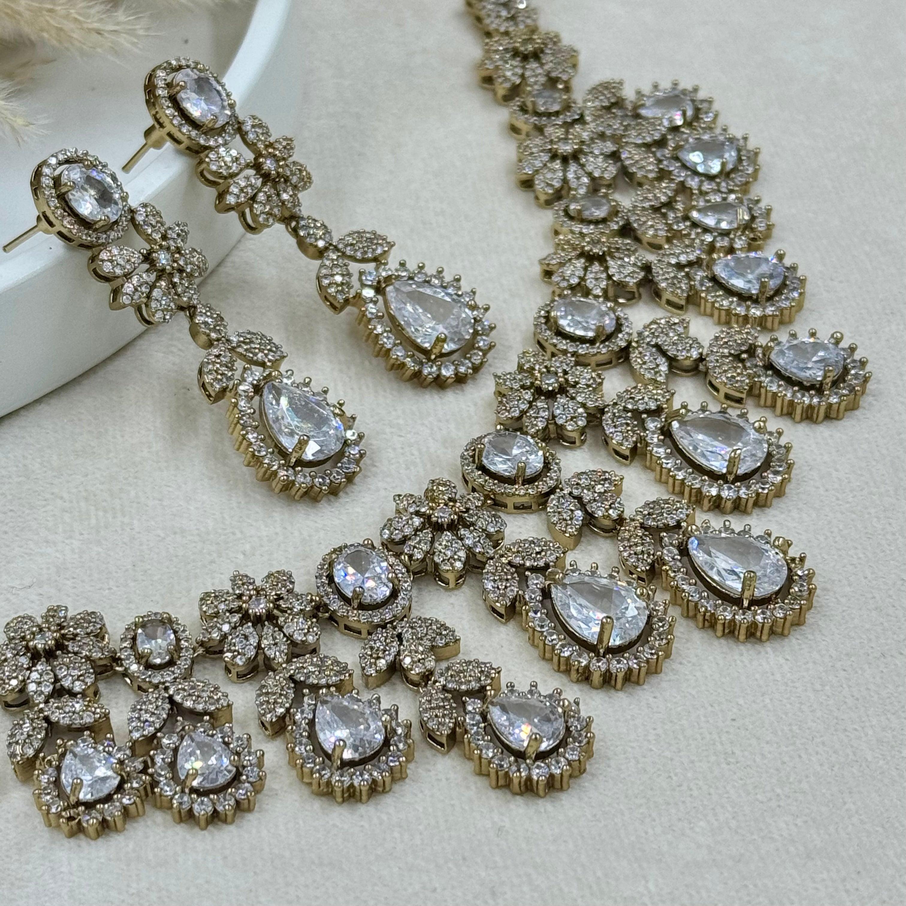 Elegant diamond necklace and earrings on a light background