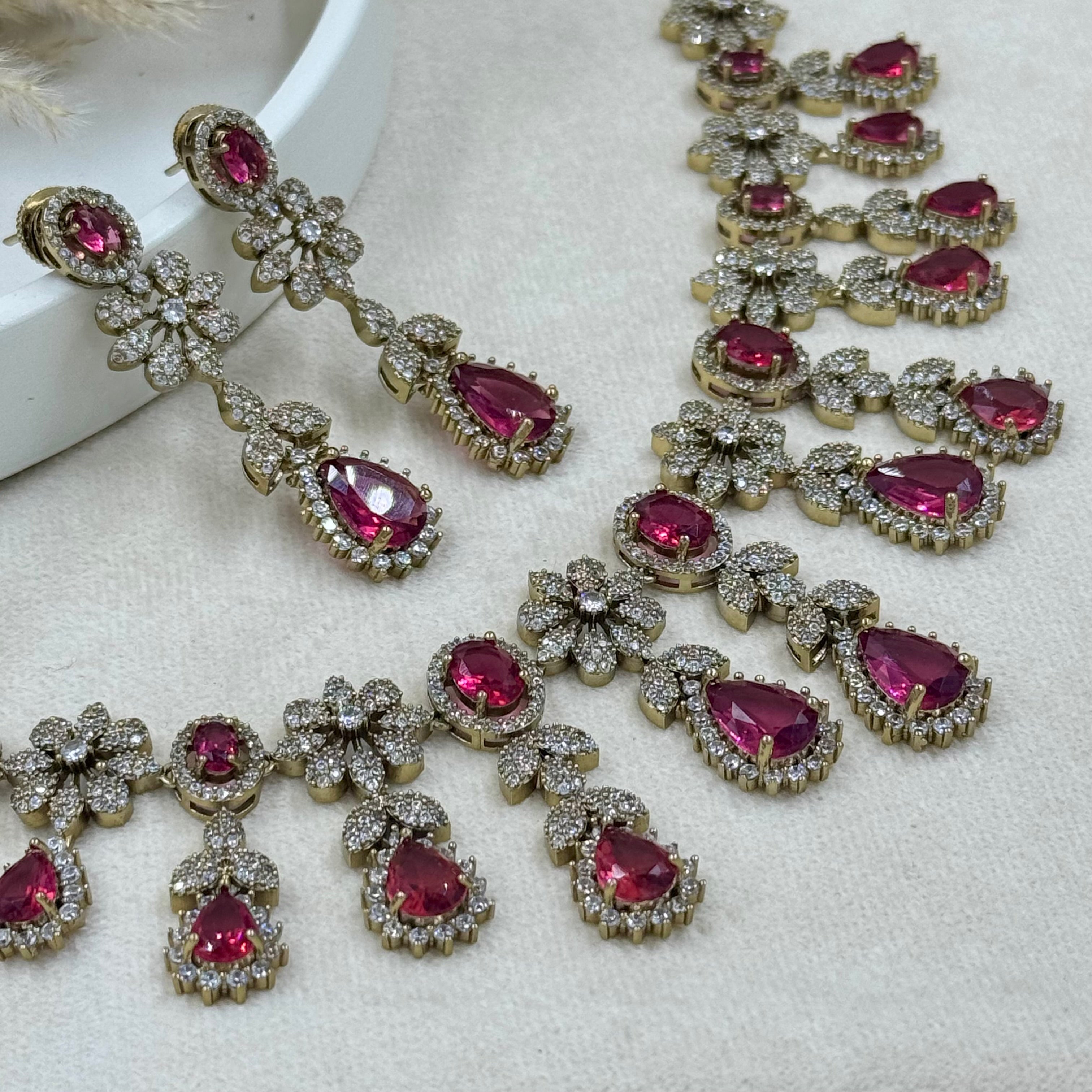 Jewelry set with pink gemstones on a white surface