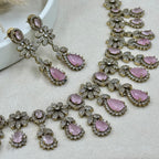 Jewelry set with pink gemstones on a light background