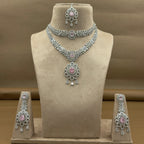 Jewelry set including necklace, earrings, and bangles on a mannequin bust.