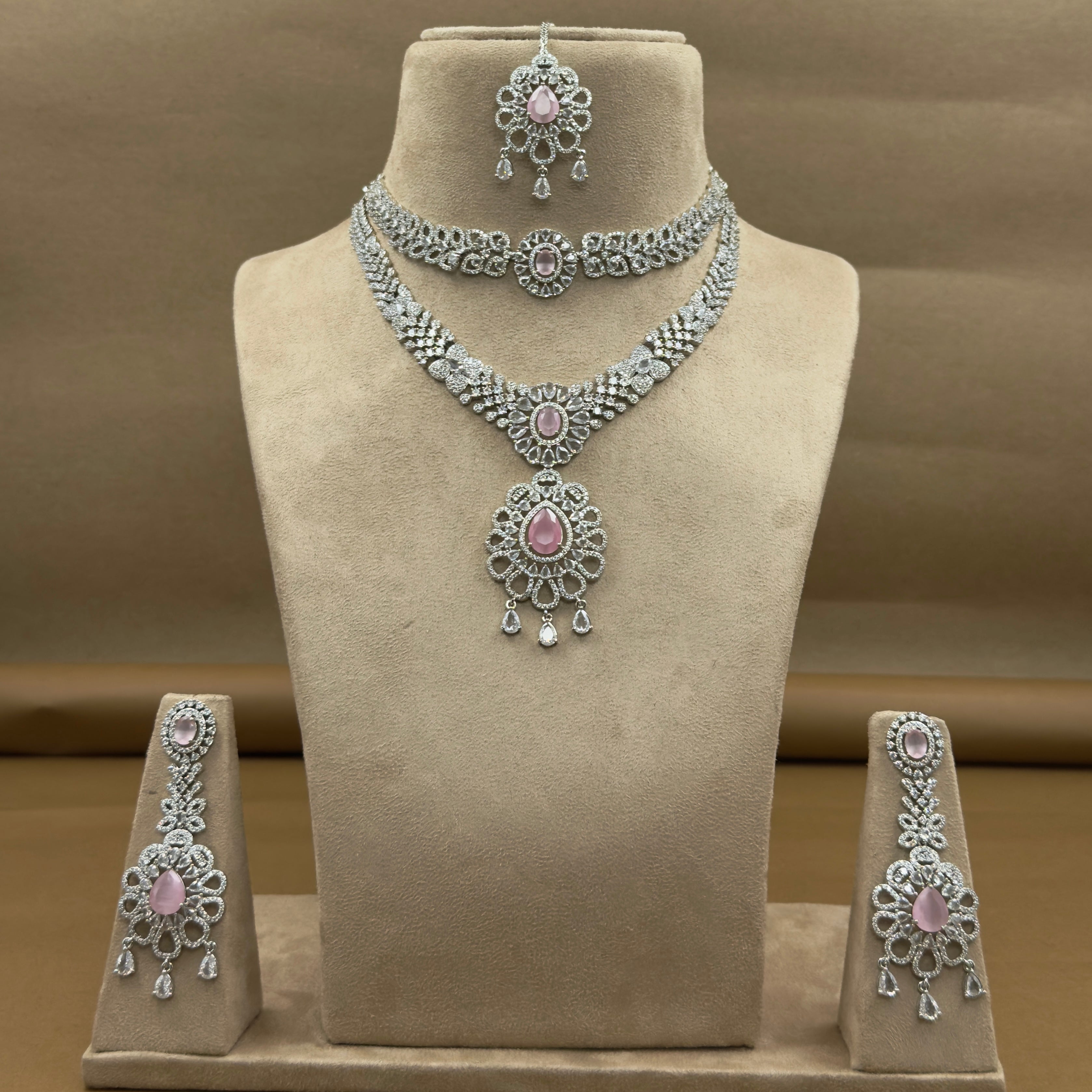 Jewelry set including necklace, earrings, and bangles on a mannequin bust.